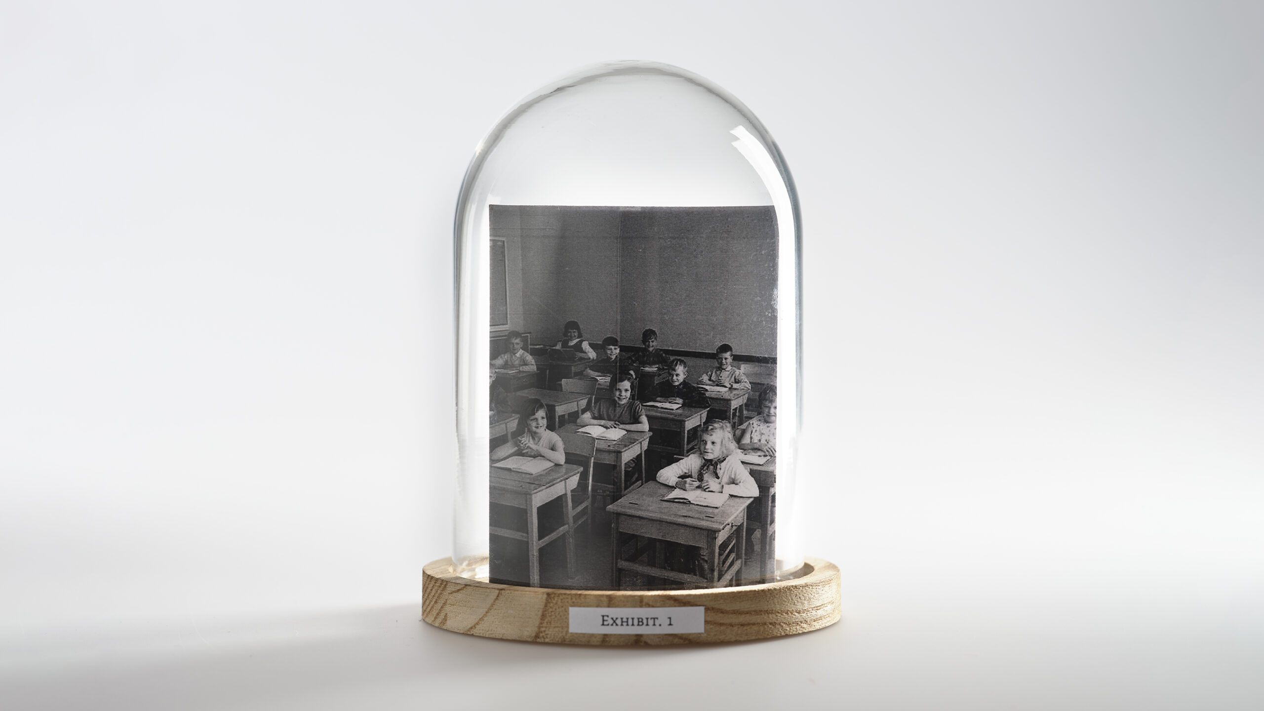 A bell jar with an image of a classroom full of children inside.