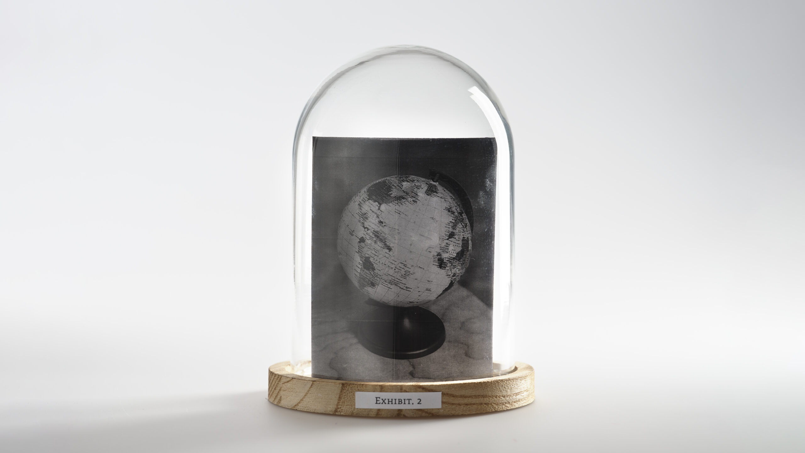A bell jar with an image of a globe inside.