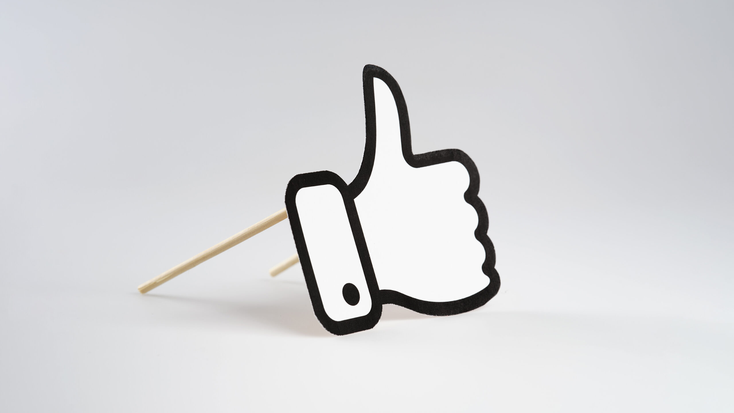 A thumbs-up/like icon, propped up as if it is a facade on a building.
